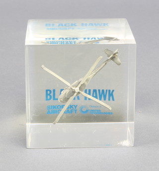 From the estate of Captain Eric M Brown a square perspex paperweight containing a model of The Black Hawk helicopter 2 1/2" x 3"