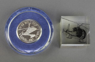 From the estate of Captain Eric M Brown a square perspex paperweight decorated a Gazelle helicopter marked Go Gazelle 2" x 2" and a glass paperweight set a "silver" medallion to commemorate the FH101 Roll Out Yeovil 1987 April 7  3 1/2" 