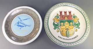 From the estate of Captain Eric M Brown a Polish Pottery charger decorated a helicopter marked PZL Swidnik Poland 13",   a German pottery charger decorated the arms of Recklinghausen 14 1/2" 