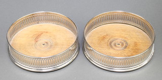 A pair of pierced silver coasters with hardwood bases London 1976 5" 