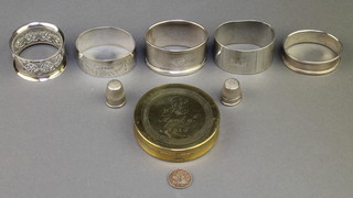 A silver engine turned napkin ring Birmingham 1933 and 3 others, a plated ditto, 2 thimbles and a 19th Century brass tobacco box 70 grams