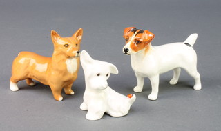 A Beswick figure of a Jack Russell 4", a ditto of a terrier with a ladybird on his tail 2" and a ditto of a Corgi 3" 