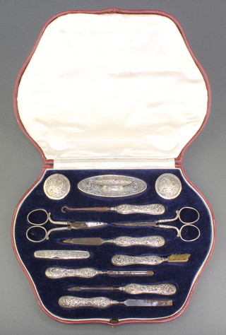 A silver mounted 12 piece manicure set in a fitted case, mixed dates