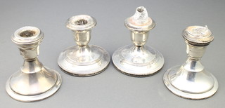 A pair of dwarf silver candlesticks of plain form Birmingham 1965 3 1/2", a pair of Sterling silver ditto 3" 