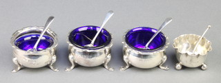 A 3 piece condiment on pad feet with 2 spoons Birmingham 1932/34, a similar ditto Sheffield 1941 with 1 spoon, 124 grams 