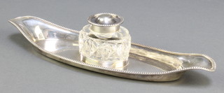 An Edwardian silver boat shaped ink stand with cut glass ink well and silver lid London 1901 10 1/2" 