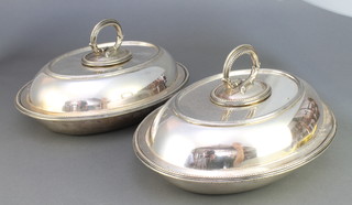 A pair of oval silver plated entrees with beaded decoration 
