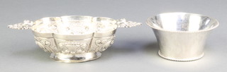 A Dutch 19th Century repousse silver 2 handled bowl with pierced handles 7", a later flared ditto with beaded decoration 3 1/2", 216 grams