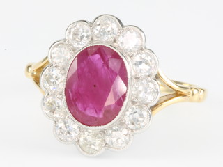 An 18ct yellow gold ruby and diamond oval ring, the centre stone approx. 1.7ct surrounded by brilliant cut diamonds approx. 0.85ct size P 1/2