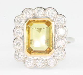 An 18ct white gold yellow sapphire and diamond ring, the centre stone approx. 3.7ct surrounded by 14 brilliant cut diamonds approx. 1.3ct, size N