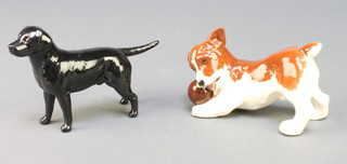 A Beswick figure of a puppy playing with a ball 4 1/2", a figure of a Black Labrador 5" 