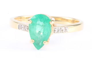 An 18ct yellow gold emerald and diamond pear shaped ring, size N 1/2