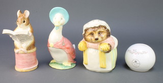 Three modern Beatrix Potter figural money banks and a spherical ditto 