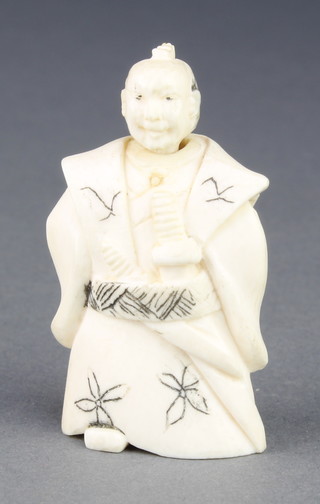A Japanese carved ivory Netsuke in the form of a standing warrior with nodding head, signed 2" 