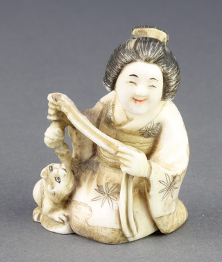 A Meiji period Japanese carved ivory Netsuke in the form of a seated Geisha with a kitten at her feet, signed 2 1/2" 