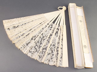 An Edwardian ivory fan with silk panels, boxed 