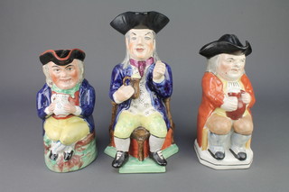 A 19th Century style Toby jug of a seated drinker 11" and 2 others 