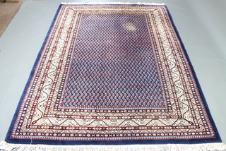 A contemporary blue ground rug with all-over geometric design 96" x 70" (some slight staining)