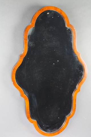 A Queen Anne style mirror of serpentine outline contained in a walnut frame 28"h x 17"w 