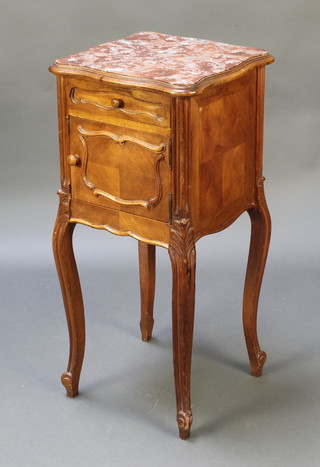 A French 19th Century carved walnut bedside cabinet of serpentine outline with pink veined marble top, fitted 1 long drawer above a cupboard, raised on cabriole supports 32"h x 15"w x 15"d 