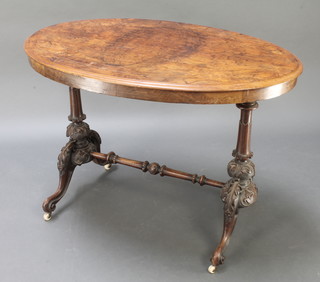 A Victorian oval inlaid quarter veneered figured walnut stretcher table, raised on turned supports with H framed stretcher 28 1/2"h x 42"w x 26"d  