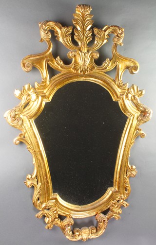 A shield shaped plate mirror contained in a gilt carved gesso frame 38"h x 24"w 