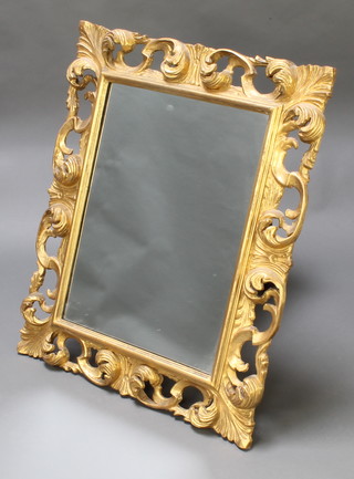 A rectangular plate mirror contained in a decorative gilt frame 32"h x 26"w 
