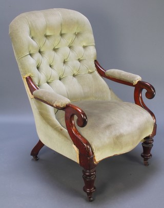 A Victorian mahogany open arm chair upholstered in green buttoned dralon, raised on turned supports