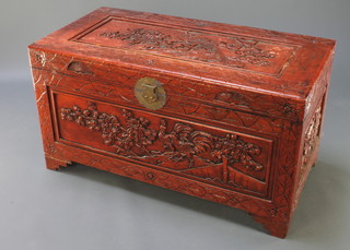 A carved camphor coffer with hinged lid, raised on bracket feet 21 1/2"h x 40"w x 20 1/2" 