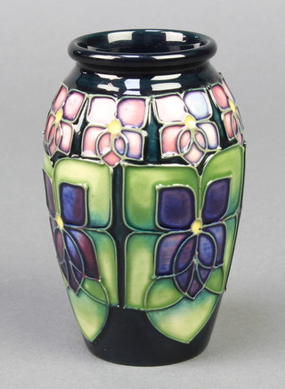 A modern Moorcroft baluster vase decorated with violets 4 1/2" 