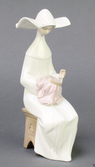 A Lladro figure of a seated nun 5501 8" 
