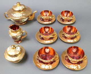 An Italian pink glass gilt decorated tea set comprising teapot, milk jug, lidded sugar bowl, 6 tea cups and 6 saucers