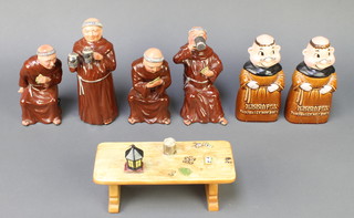 A Continental porcelain group of 4 monks playing cards and drinking around a table together with a pair of ditto money banks