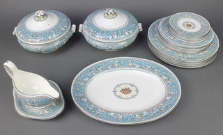 A Wedgwood dinner service comprising 7 small plates, 7 medium plates, 7 dinner plates, 1 serving plate, 2 lidded tureens, a sauce boat and stand