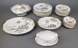 A 20th Century Japanese dinner service decorated with landscapes and flowering wisteria comprising 8 small dishes, 8 medium bowls, 8 dinner plates, 1 lidded tureen, a serving dish, bowl and sauce boat 