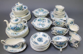 A Masons ironstone fruit basket tea and dinner service comprising 6 tea cups, 10 saucers, 4 two handled cups, 9 saucers, 10 small plates, 9 medium plates, 8 dinner plates, 2 lidded tureens, a sauce boat and stand, a serving plate, a preserve pot and lid, a bowl 9 dessert bowls 