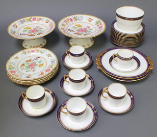 An Edwardian blue and gilt tea set comprising 4 cups, 8 saucers, 12 small plates, 2 serving plates and a slop bowl together with a Copeland Heron pattern dessert service of 2 tazzas and 6 plates