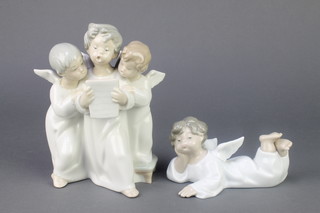 A Lladro figure of a reclining angel 5 1/2", a ditto group of 3 singing angels 7" 