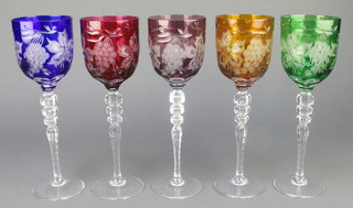 Five cut glass coloured hocks with vinous decoration 8" 