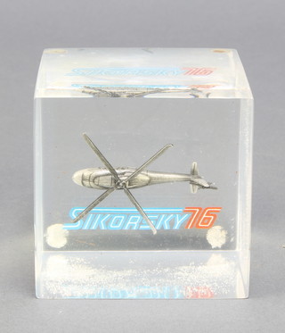 From the estate of Captain Eric M Brown a square perspex paperweight containing a model of a Sikorsky 76 helicopter 3" x 3" and  a square perspex paperweight containing a model of The Black Hawk helicopter 2 1/2" x 3"