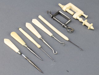 A Victorian turned ivory needlework bobbin clamp 4", a polished steel needlework clamp 2" etc