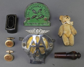 A miniature yellow teddybear with articulated limbs 3 1/2", a 19th Century lacquered snuff box 1" x 2" x 1", a 19th Century turned wooden whistle 2 1/2", an AA radiator badge and a do. National Trust 