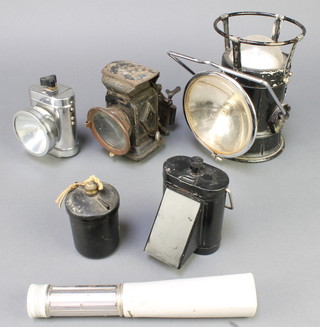 A carbide bicycle lamp, a Second World War Ever Ready hand lantern with deflector and 3 other torches, a circular black Bakelite container 