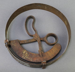 A 19th Century brass and iron circular hat gauge, calibrated from 5 1/4 to 7 3/4 
