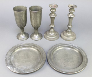 A Methodists communion set comprising 2 circular patents 9", 1 with slight corrosion, a pair of chalices 8", a pair of candlesticks with ejectors 9" (1f), the chalices and the tray marked IHS 