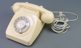 A British Telecom cream dial telephone