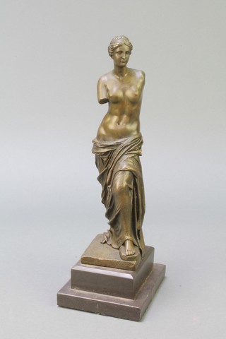 A bronze figure of a standing Venus de Milo, raised on a stepped black marble base 12"