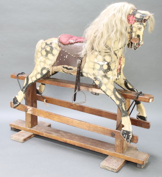 A dappled grey rocking horse with real hair mane and tail on a wooden frame base 50"h x 53" 18" 