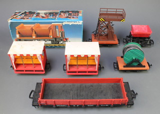 2 LGB Lehmann 3041 Summer-type passenger coaches, a 4046 cable wagon, a 4043 dripping-bucket wagon, a 3530 Catenary Tower wagon and a 4061 low-sided wagon and a Playmobil 4112 double-bucket tipping wagon, all boxed 
