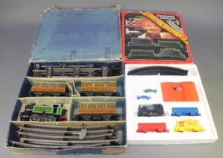 A Hornby Type 101 clockwork tank engine with 3 carriages and rails, there is some slight paint loss to the rear of the tender and a Hornby clockwork Superset R533, both boxed